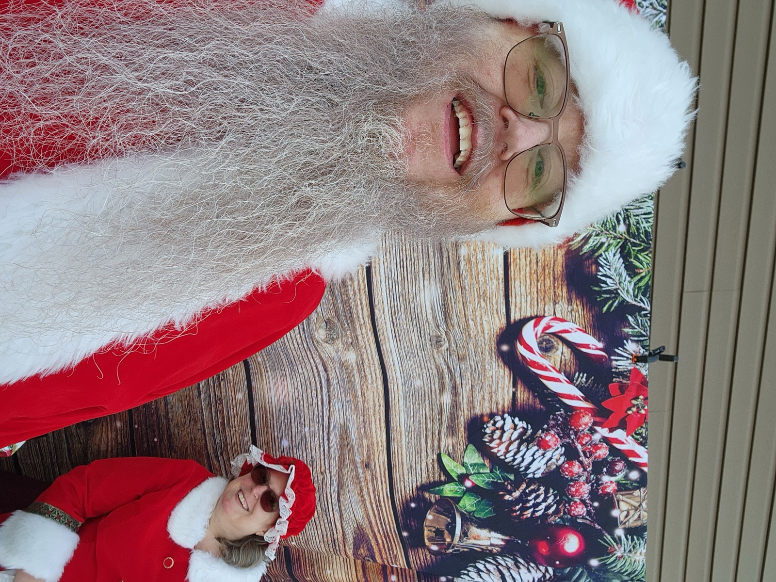 Close-up of Santa in front of a festive holiday backdrop