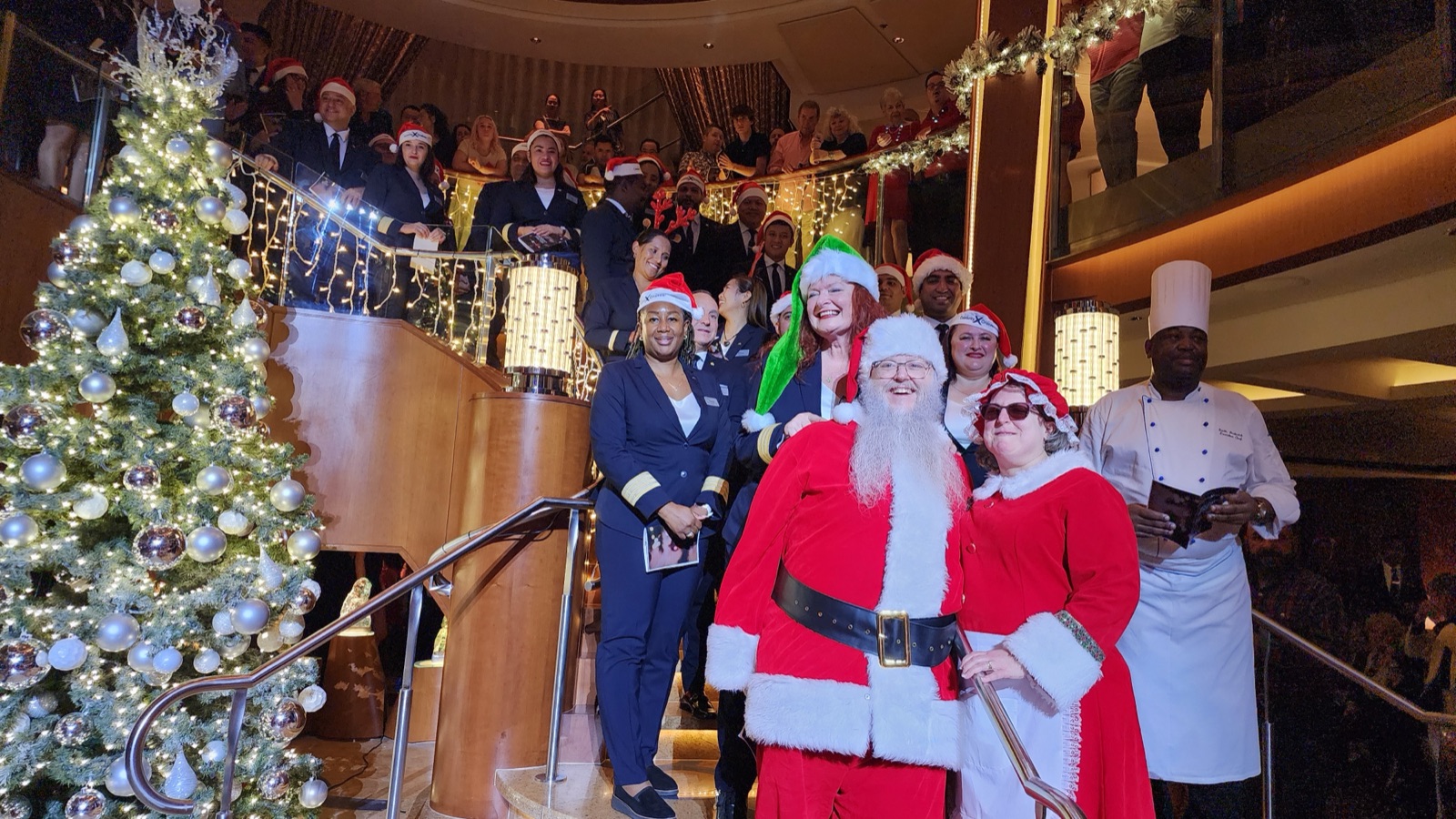 Santa and Mrs. Claus with crew at a holiday event