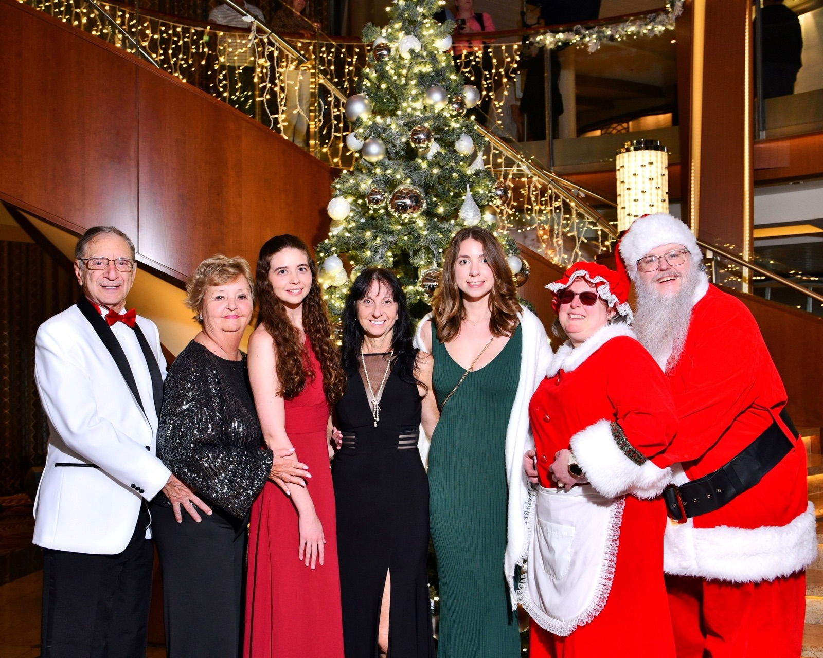 Santa and Mrs. Claus with a family at a holiday celebration